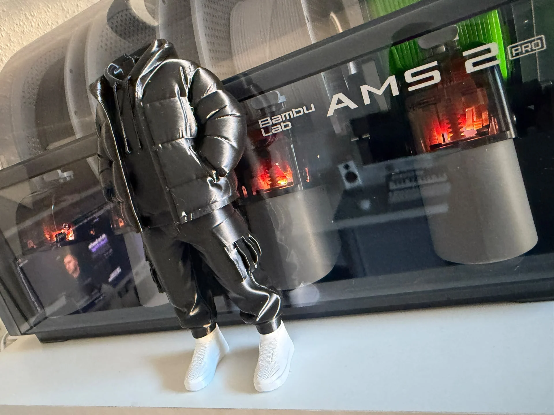 A headless printed figure standing in front of my Bambu Lab AMS 2 Pro